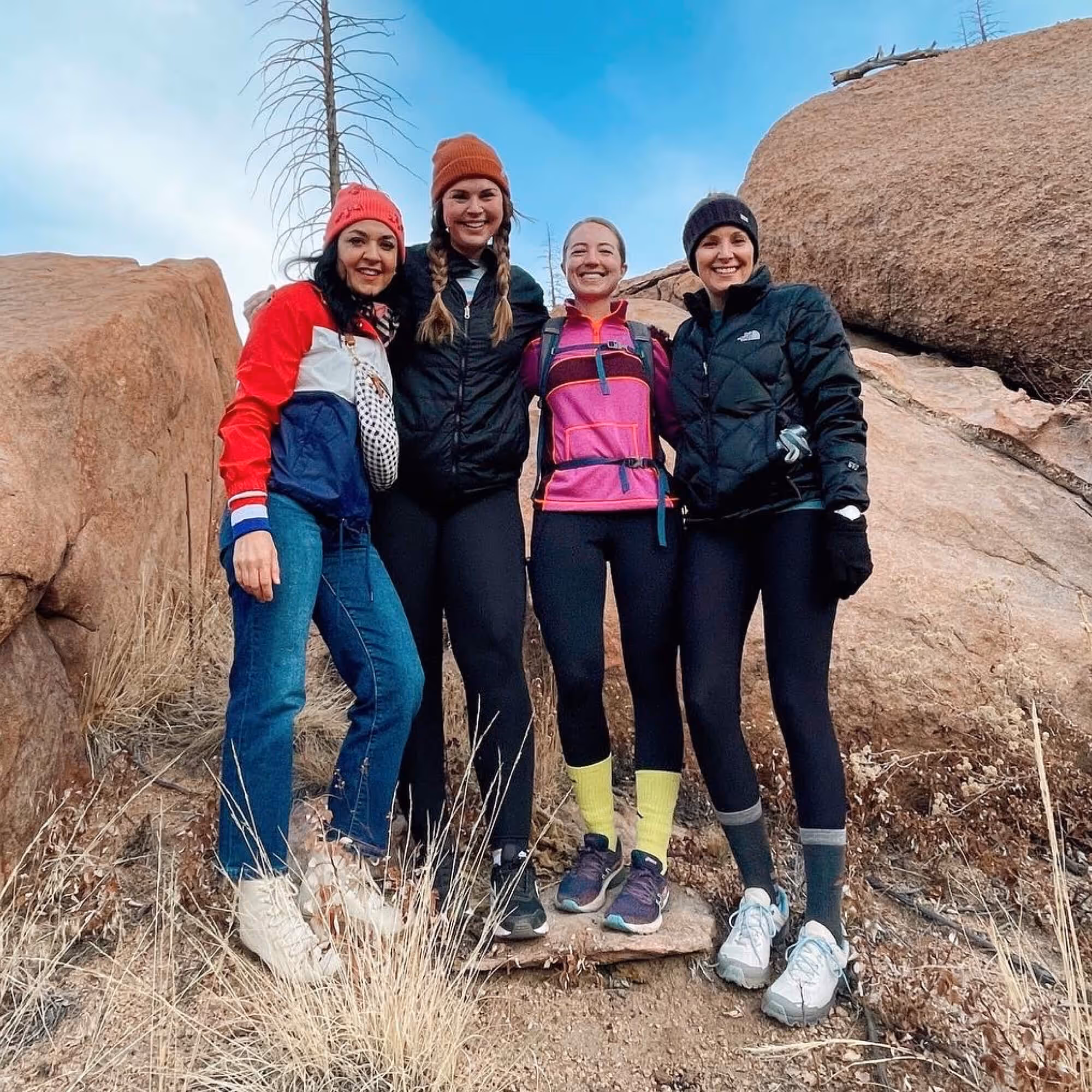 Four female TSE team members smile while taking a photo during the 2021 TSE Colorado Retreat.