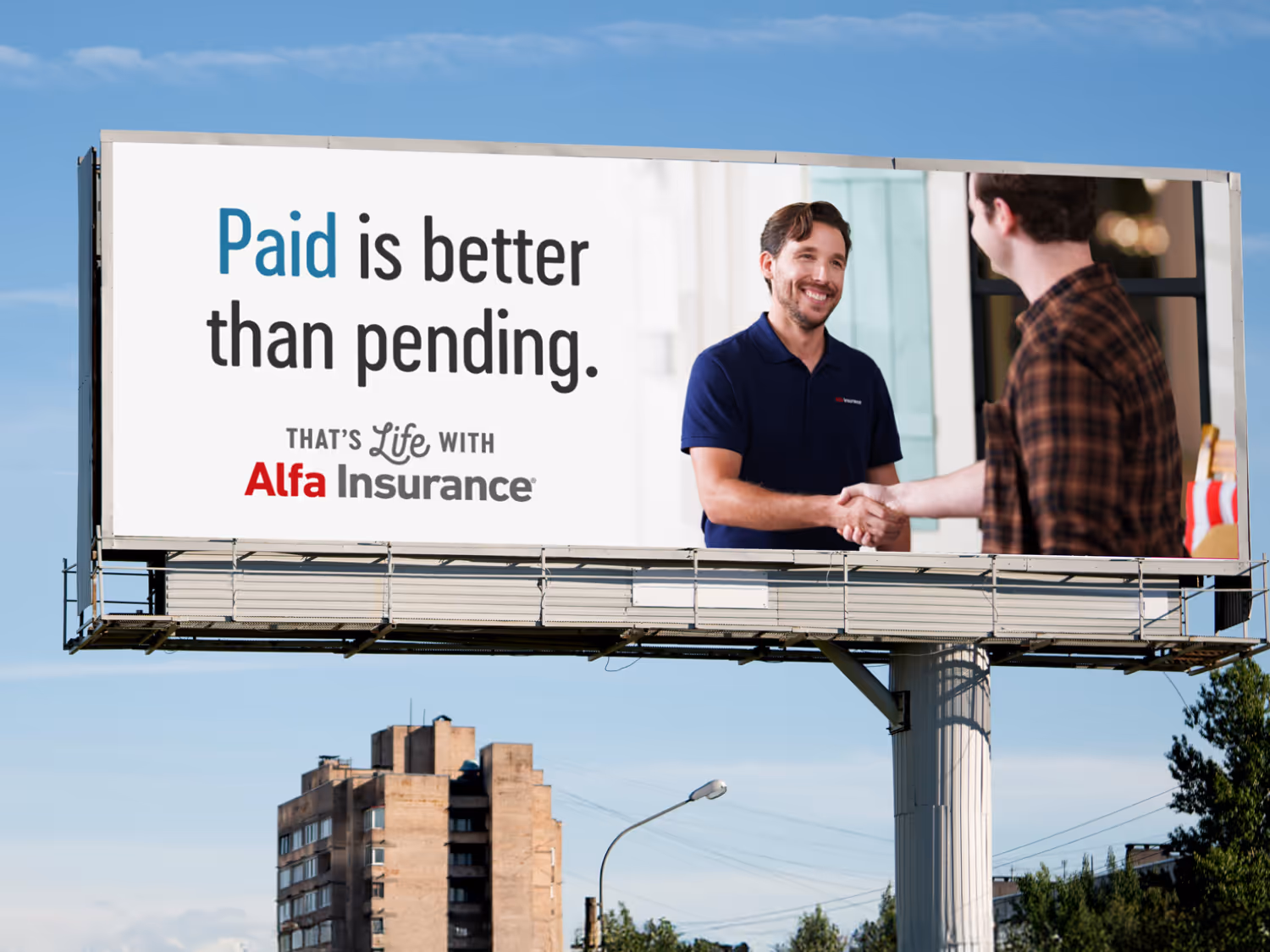 Billboard showing a man in a navy polo shaking hands with another man, alongside the text 'Paid is better than pending. That's Life with Alfa Insurance.'