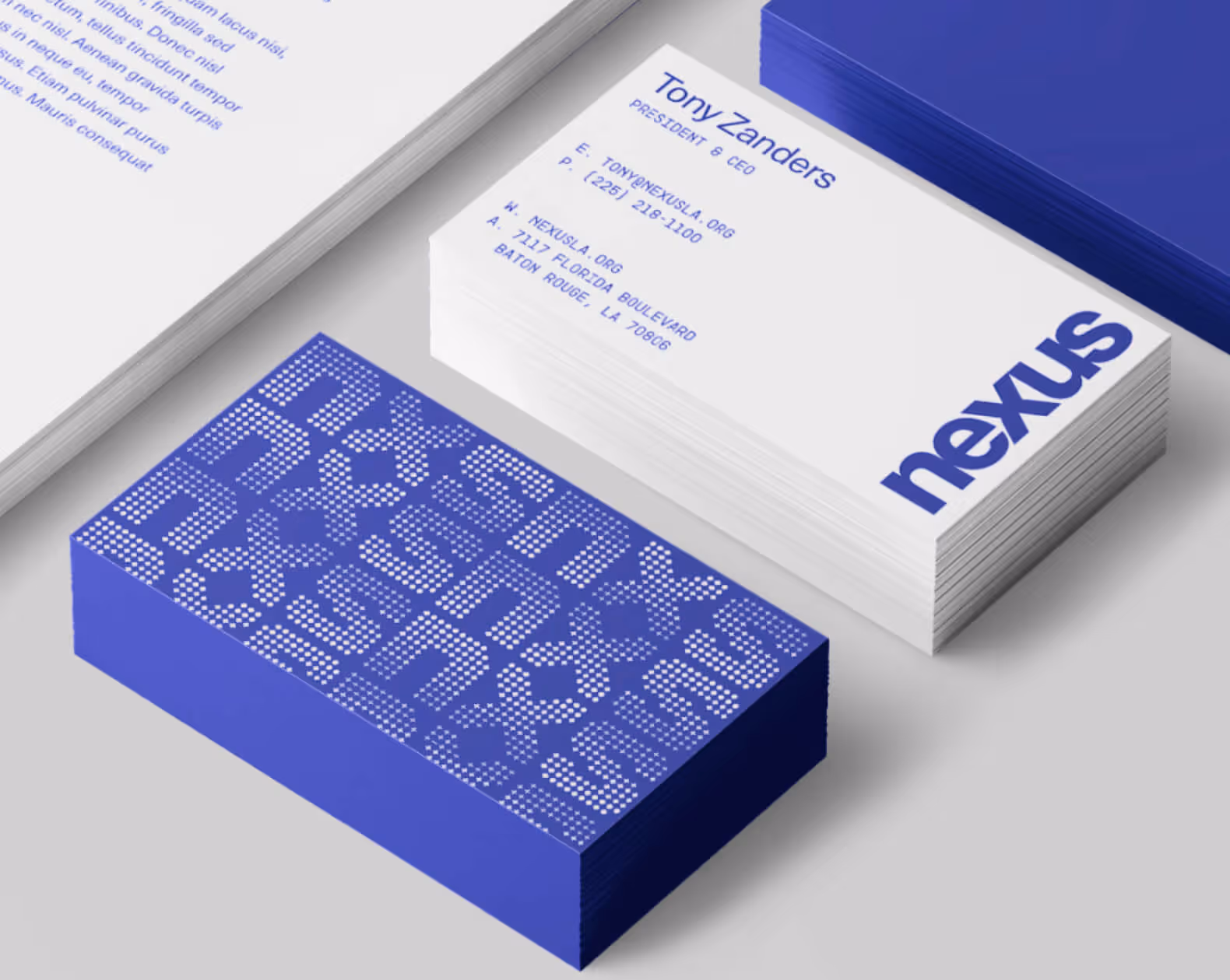 Stack of business cards for Tony Zanders, President & CEO of Nexus, with contact details and a blue dotted pattern on the back.