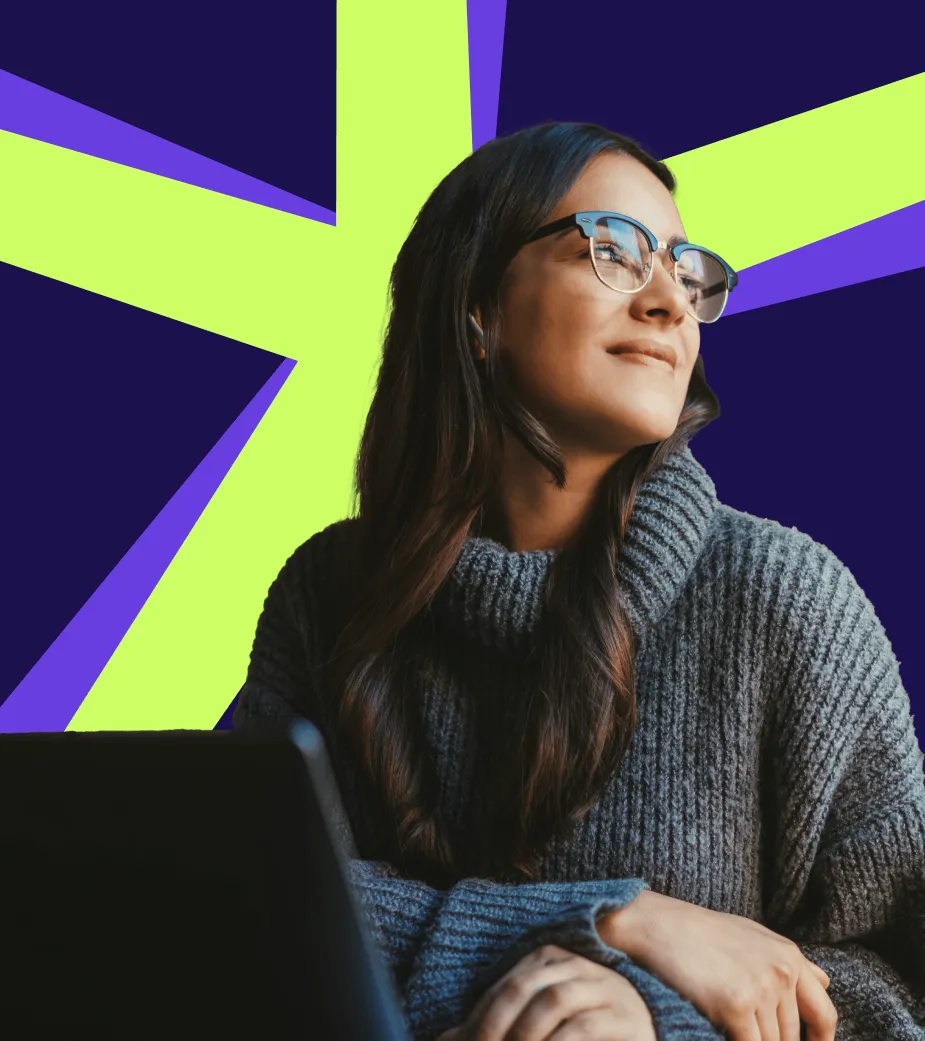 Woman with glasses and long dark hair wearing a gray knitted sweater, sitting with folded hands, looking thoughtfully to the side against a dark background with bright green and purple geometric shapes.