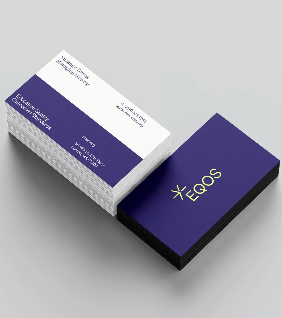 Stack of business cards with the name Suzanne Towns, Managing Director, and EQOS logo on a purple background.
