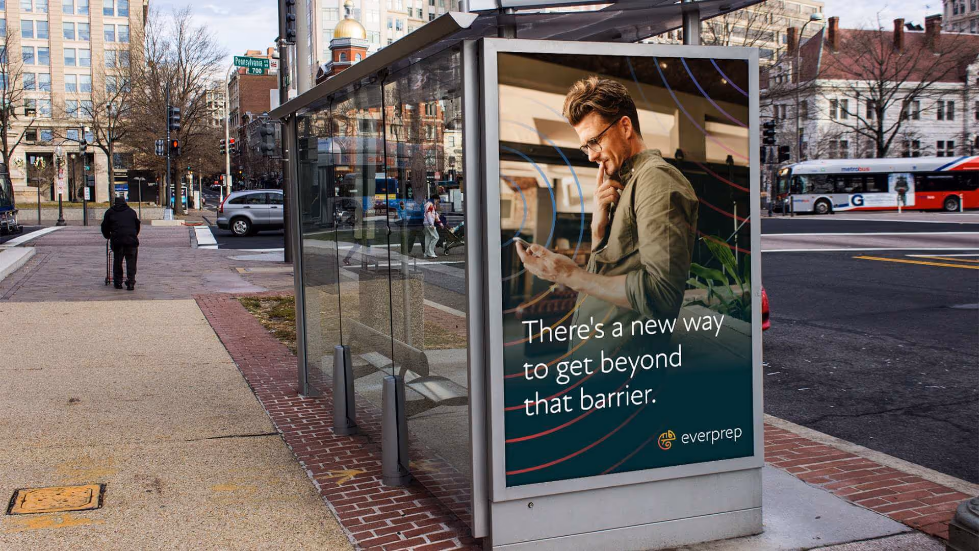 Bus shelter ad showing a man looking at his phone with text: There's a new way to get beyond that barrier.