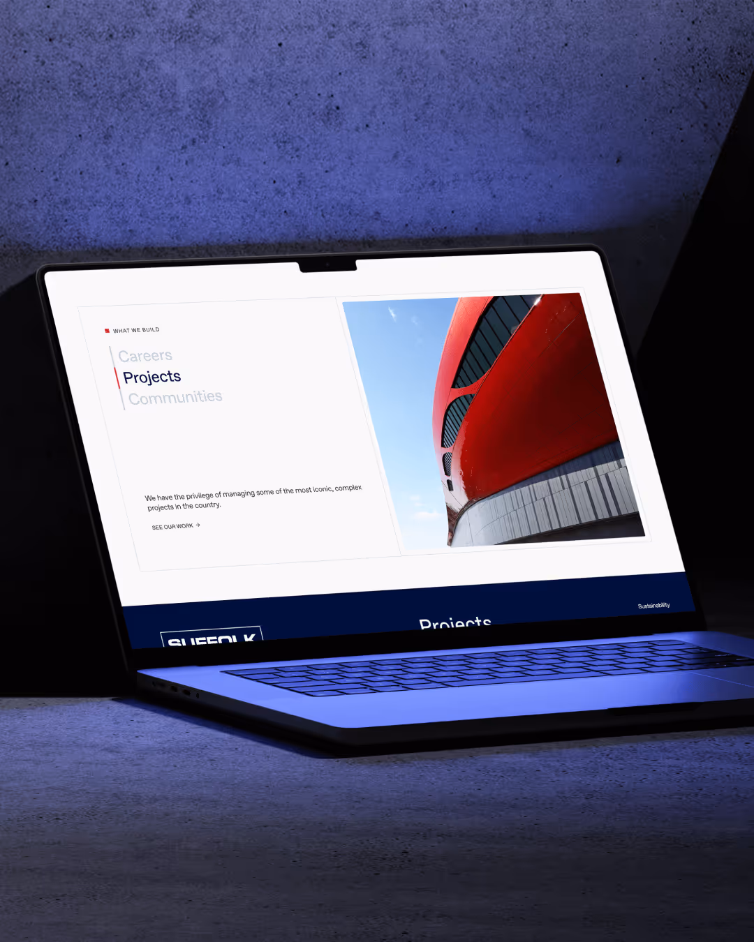 Laptop screen displays a website section titled Projects with a red architectural structure photo and menu options for Careers, Projects, and Communities.