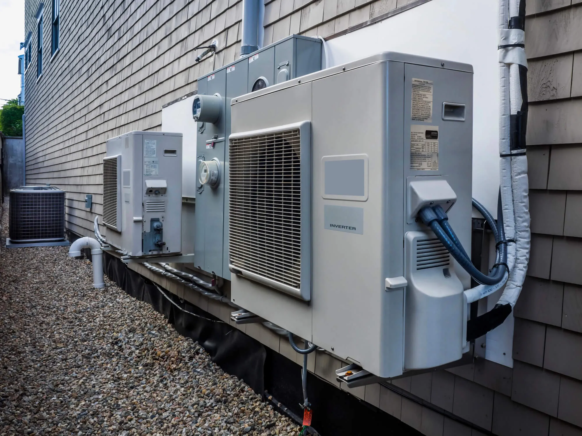 Newly installed outdoor heat pump units on the side of a home