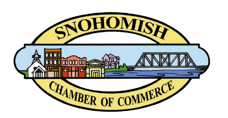 Logo with a yellow oval border containing the text 'Snohomish Chamber of Commerce' around a scene of small colorful buildings, a body of water, and a truss bridge under a blue sky.