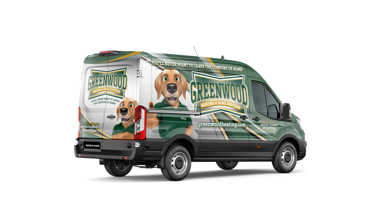 Green and white service van with a dog mascot in a green shirt on the side and rear, branded with Greenwood Heating & Home Services, slogan 'You'll never want to leave the comfort of home!', and services listed as heating, plumbing, air, and electrical, along with the website greenwoodheating.com.