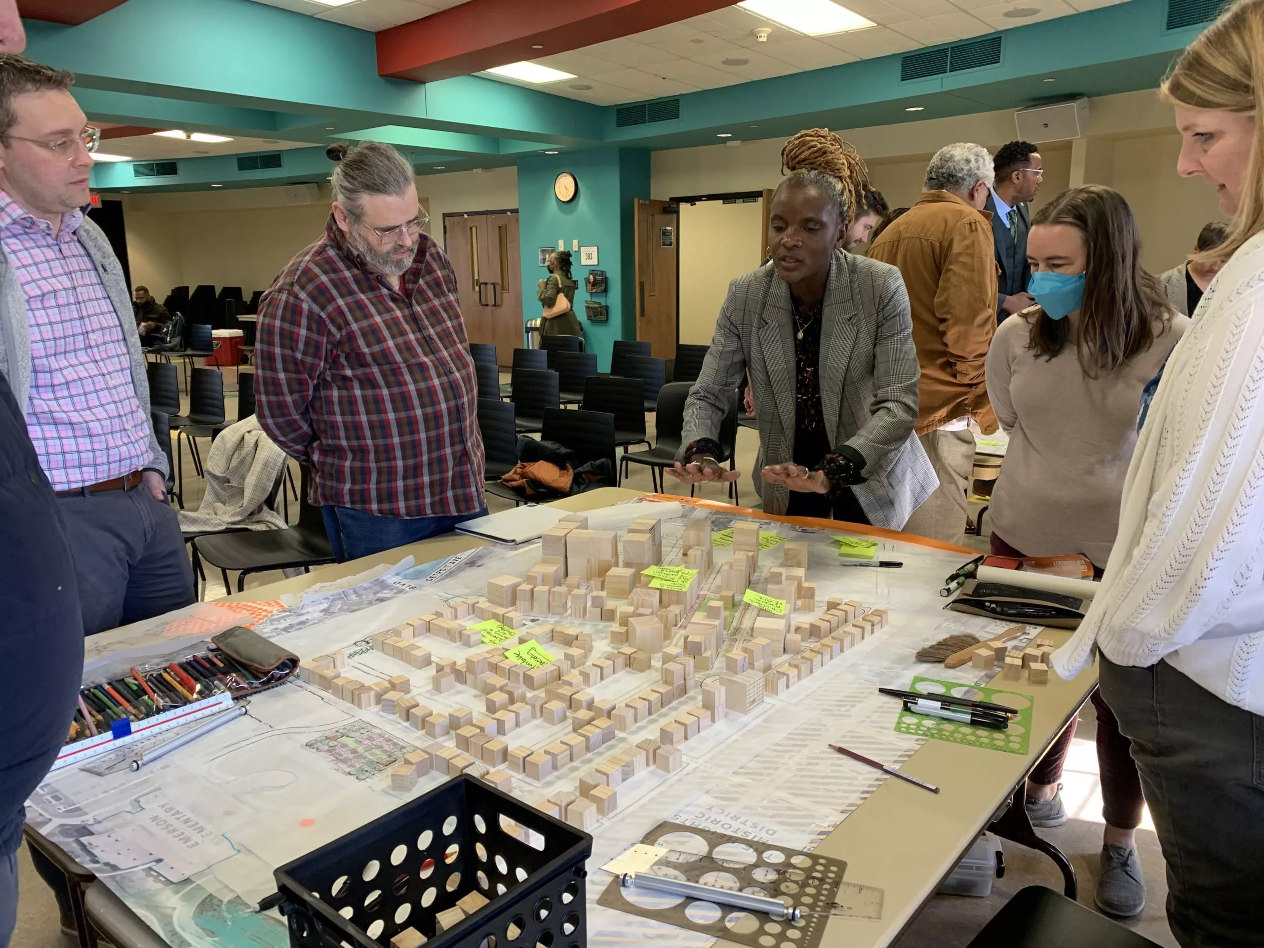 facilitator discusses micro scale exhibit of plan to group