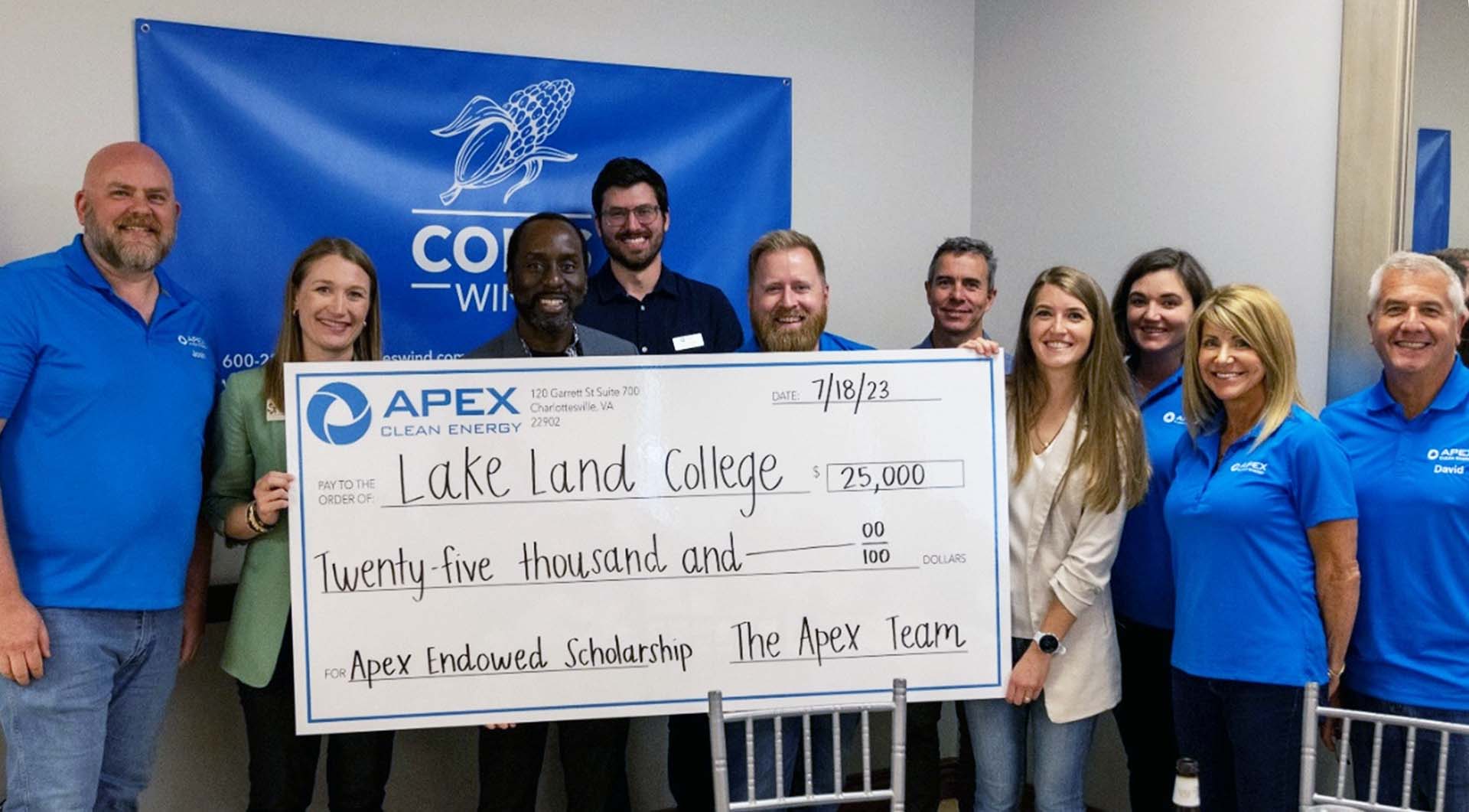 Group of people smiling while holding a $25,000 Apex Clean Energy check for Lake Land College.