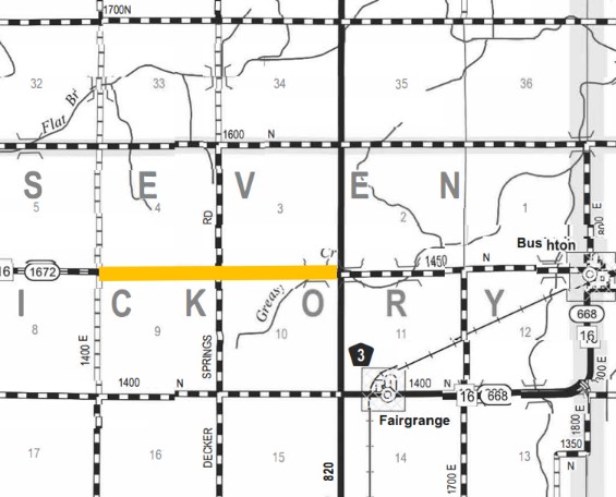 Black and white map segment highlighting a horizontal road in yellow crossing counties labeled SEVEN and VICKORY, with other roads and small towns like Fairgrange and Bushton marked, including road numbers 16, 668, 820, and 1400 E.