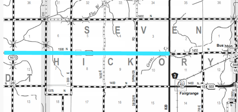 Black and white map segment showing sections of Severn and Hickory towns with roads, section numbers, and labels such as Springs and Decker roads, Fairgrange town, and Bushton to the northeast. A horizontal blue line crosses the map from left to right.