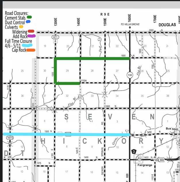 Map section showing road closures and work zones in Seward and Hickory areas, with legends for cement stabilization in green, dust control in blue, culverts in yellow, widening and adding rock in red, full-time closure from April 6 to May 11 in pink, and cap rock in orange. Green line indicates cement stabilization on roads near 29 and 1700N, blue line for dust control crosses horizontally near 1500N and 1673. Roads and major route numbers, township and range grid, and town names like Fairgrange and Douglas are marked.