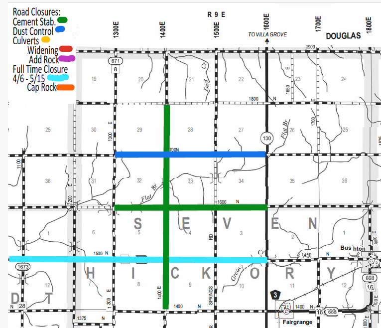 Map showing road closures in Douglas area labeled by type and color: green for cement stabilization, blue for dust control, yellow for culverts, red for widening, purple for adding rock, dark pink for full-time closure from April 6 to May 15, and orange for cap rock. Green vertical and horizontal lines indicate cement stabilization on roads 1400E and 1600N. Blue lines for dust control are on 700N and 1450N roads. Orange lines for cap rock are on roads 1500N and 1673. Black and white checkerboard roads show boundaries and other roads labeled with numbers and intersecting sections.