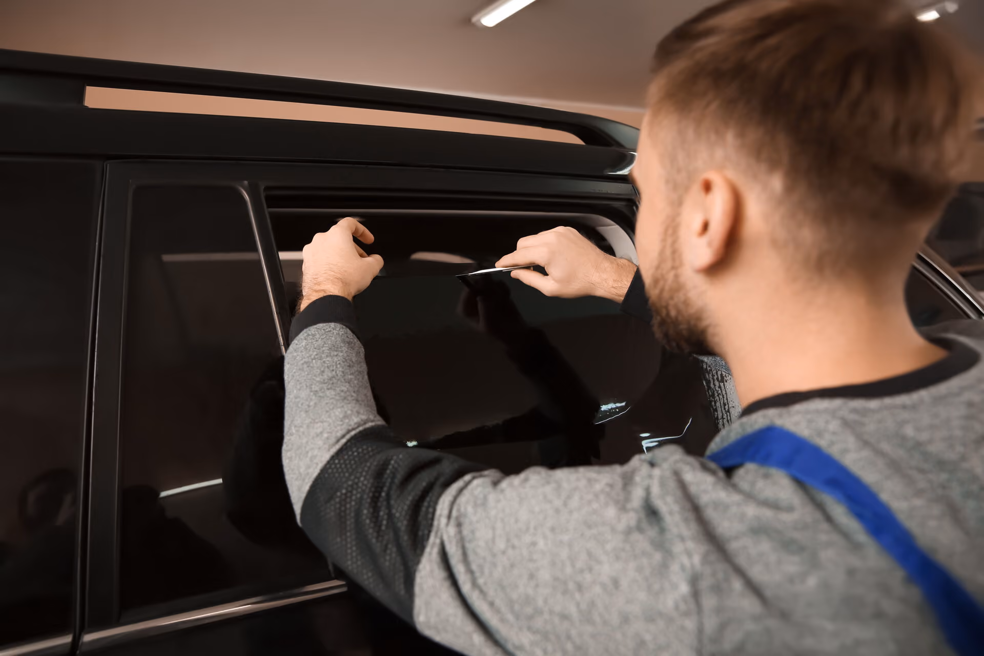 Window tint film being fitted to a rear side window