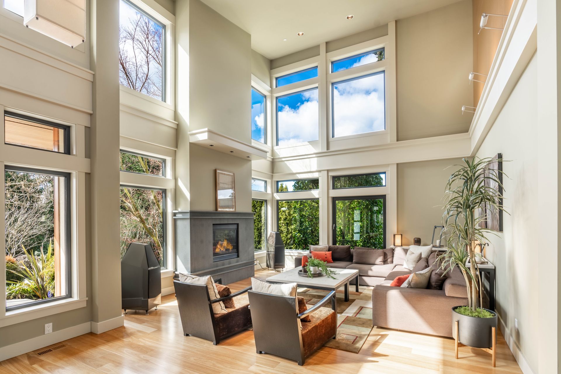 Bright living room with tall windows, the kind of glass home window film is installed on