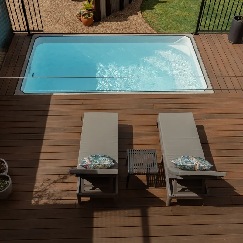 The plunge pool and two loungers on the timber deck