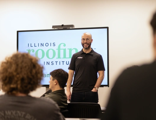 Dante Sabel in front of the Illinois Roofing Institute logo during a class