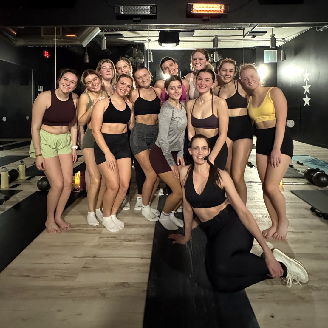 A private group gathered in the floor studio with their instructor after class