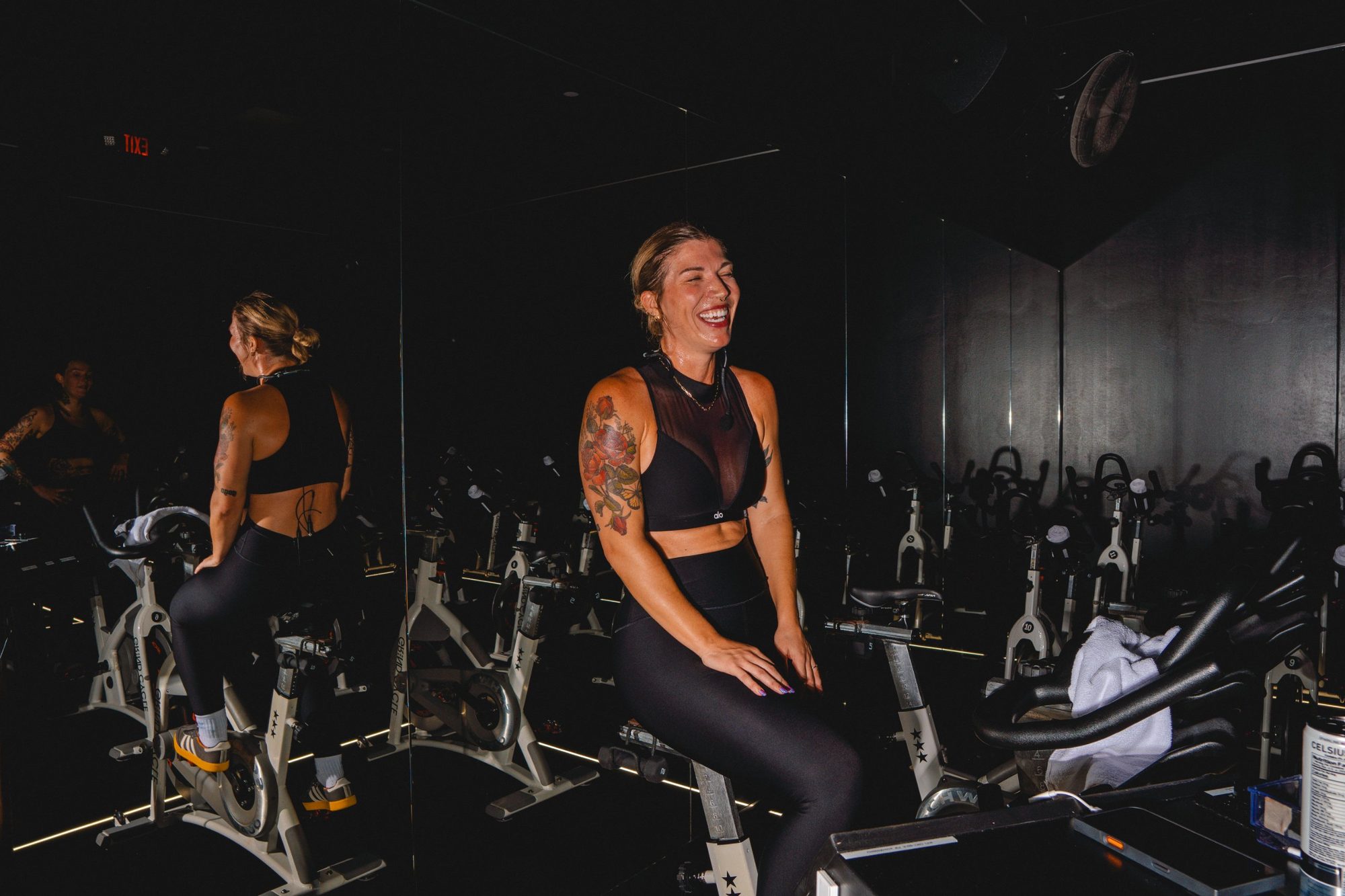 Instructor laughing on the bike after class