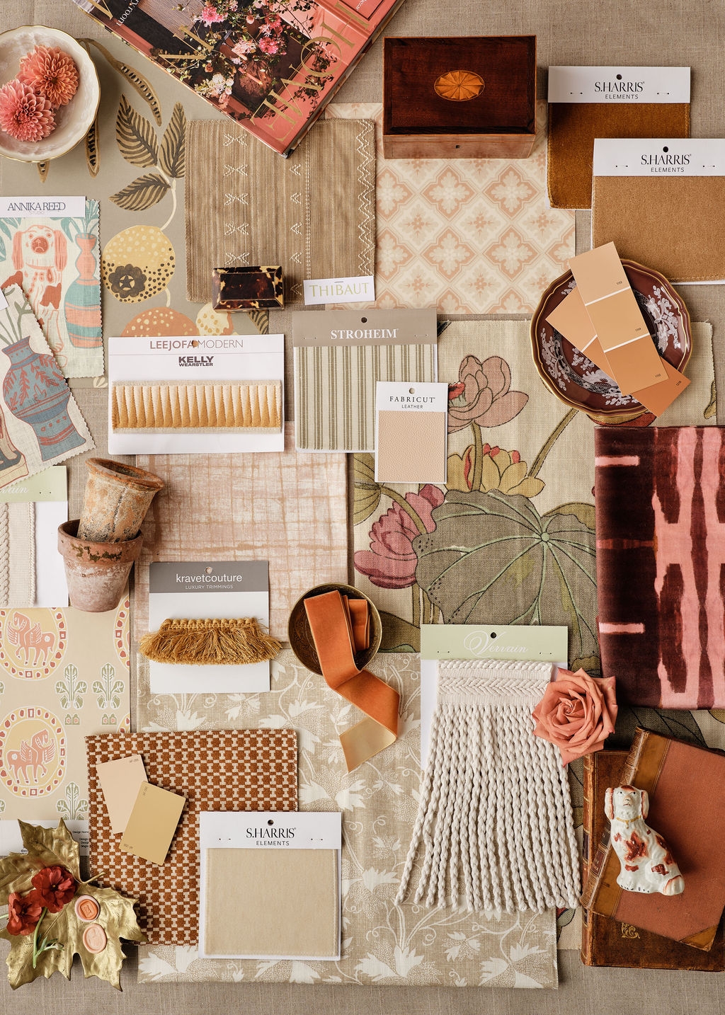 Two designers comparing fabric samples at a table in front of the showroom library