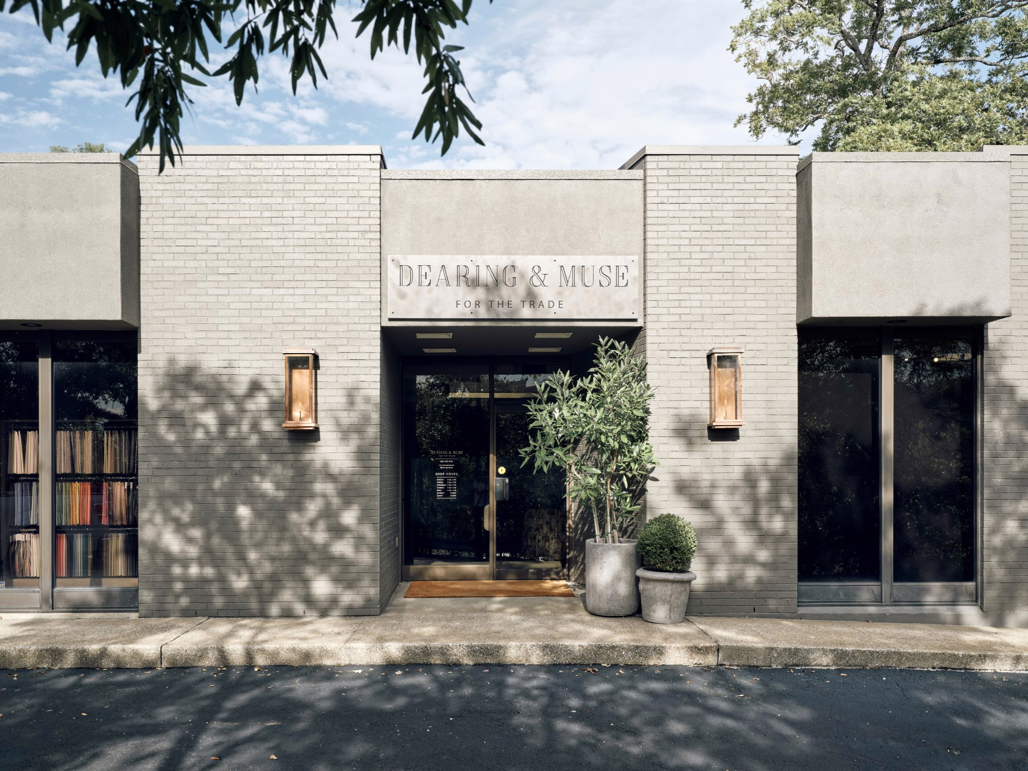 Dearing and Muse showroom exterior with painted brick and the sign above the door