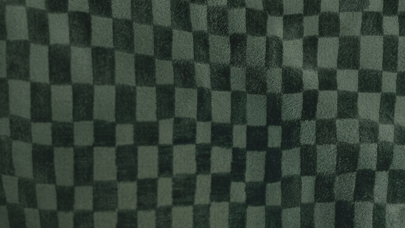Close-up of a moss green cut velvet with a pebble pattern