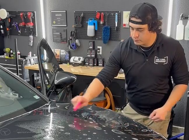 Gavin installing paint protection film on a hood