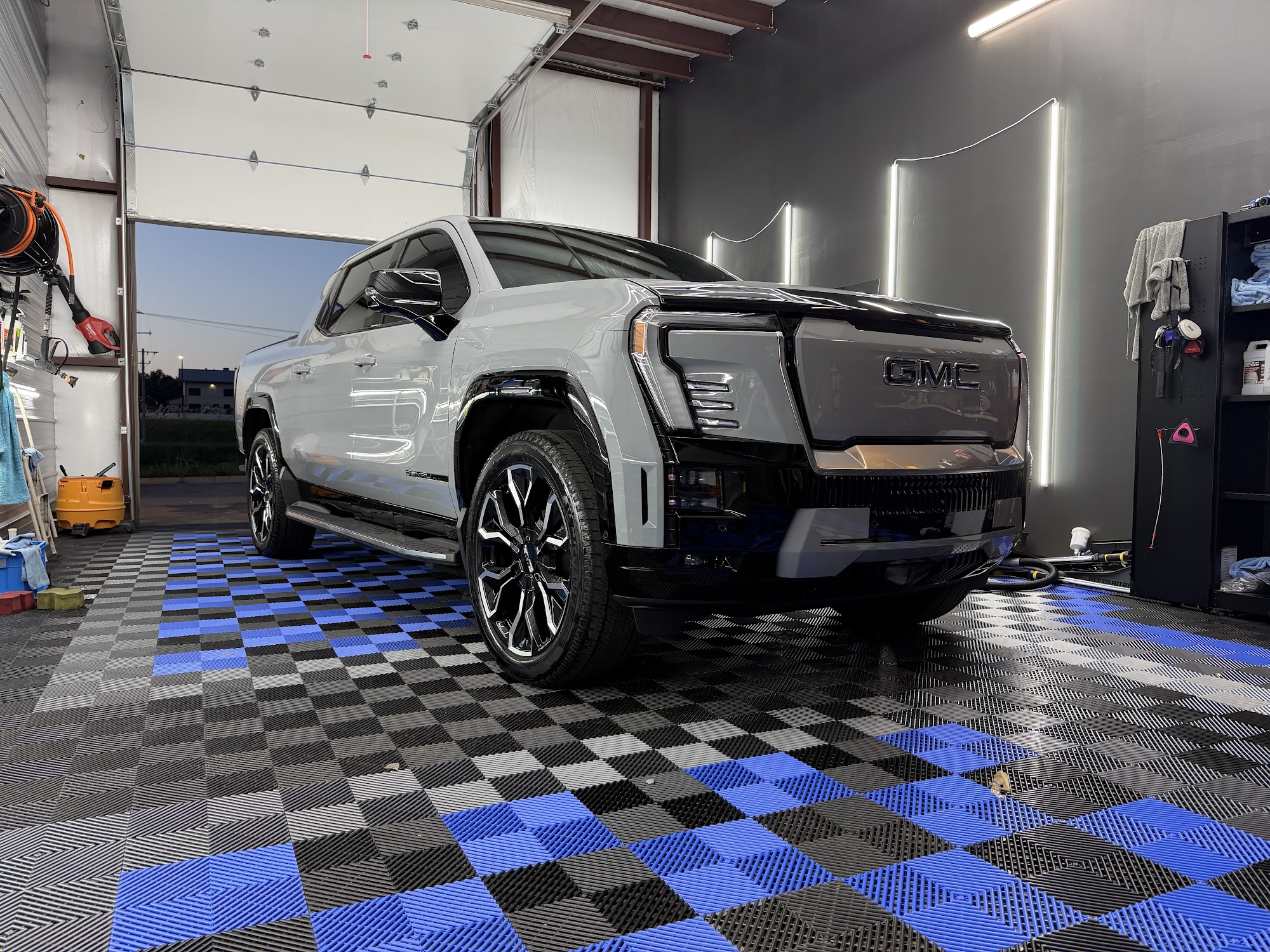 Silver GMC Sierra EV with bumper paint protection film and a ceramic coating in the Detail Armor studio