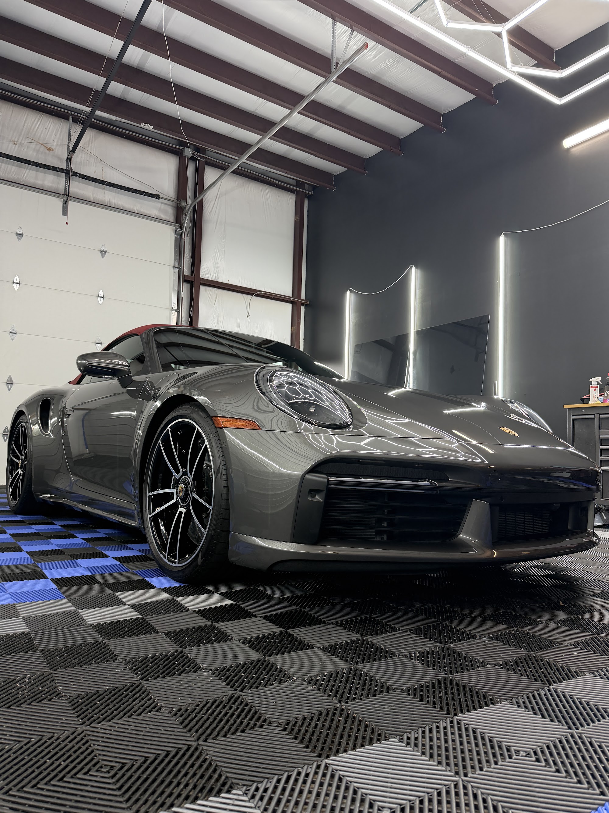Gray Porsche 911 Turbo S with a full ceramic coating and window tint in the Detail Armor studio
