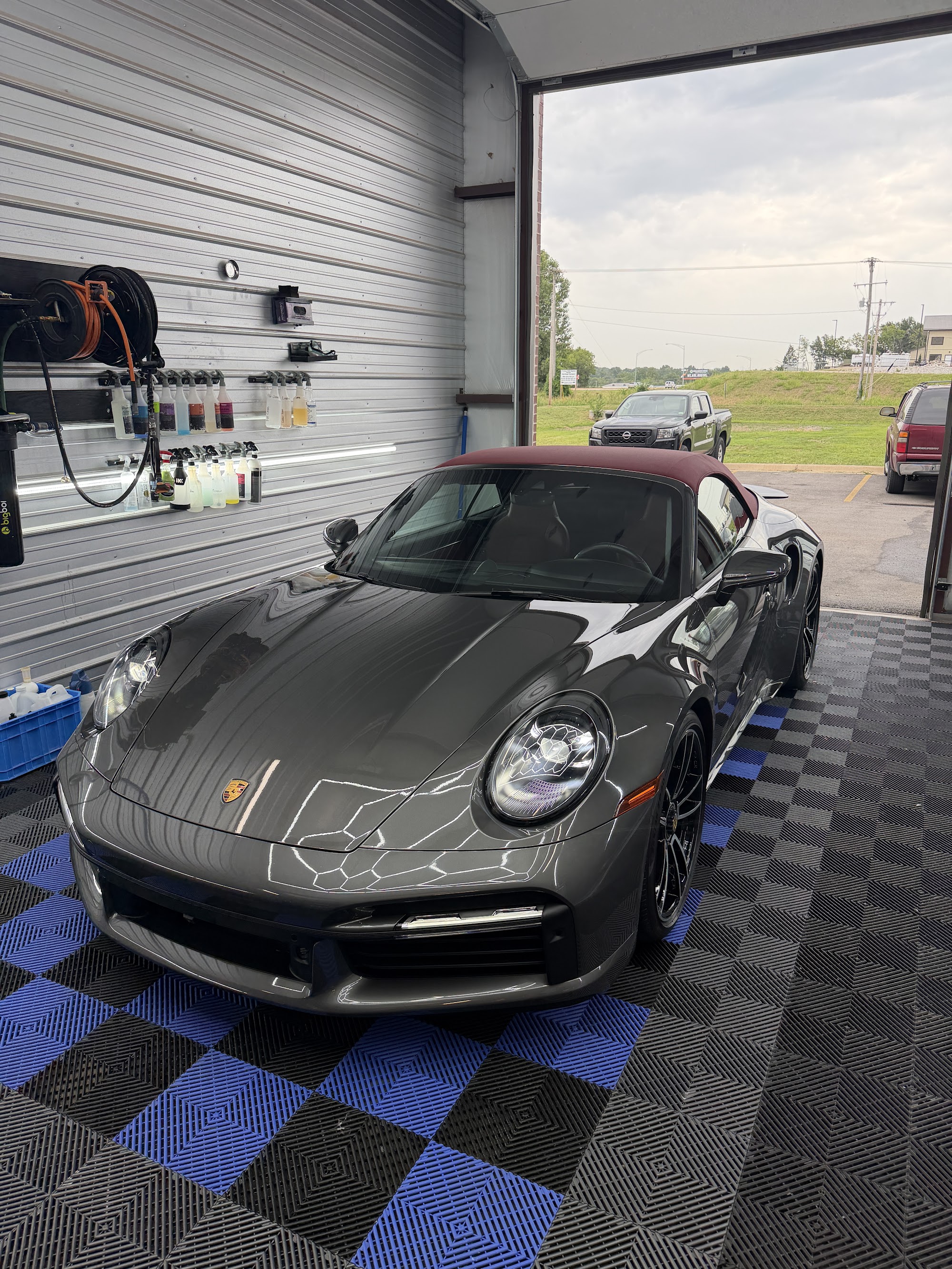 Side of a gray Porsche 911 Turbo S with a ceramic coating and window tint
