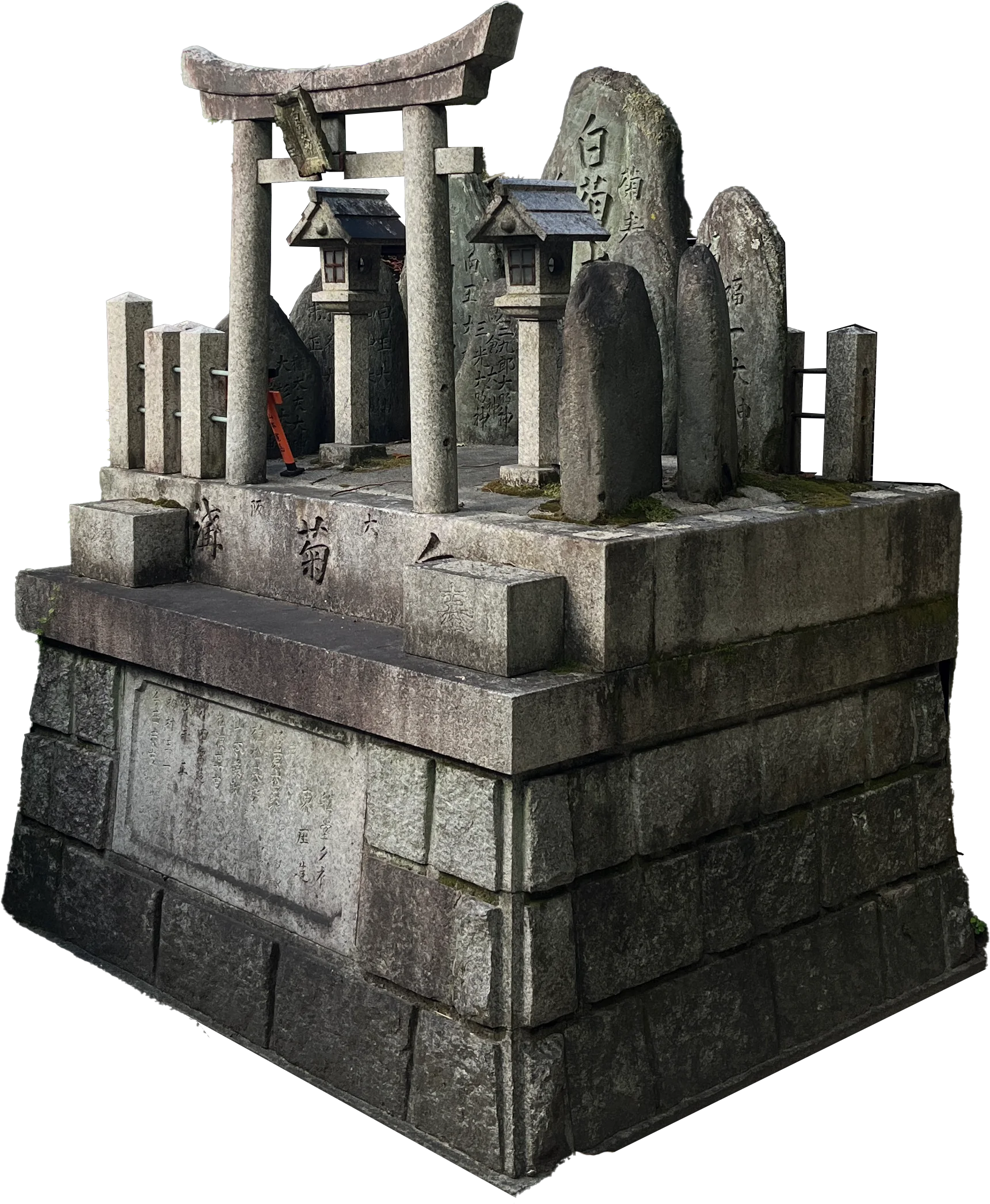 A small stone shrine on a tiered granite base: a torii gate, two miniature roofed shrines and a group of inscribed standing stones, photographed and cut out against the page.