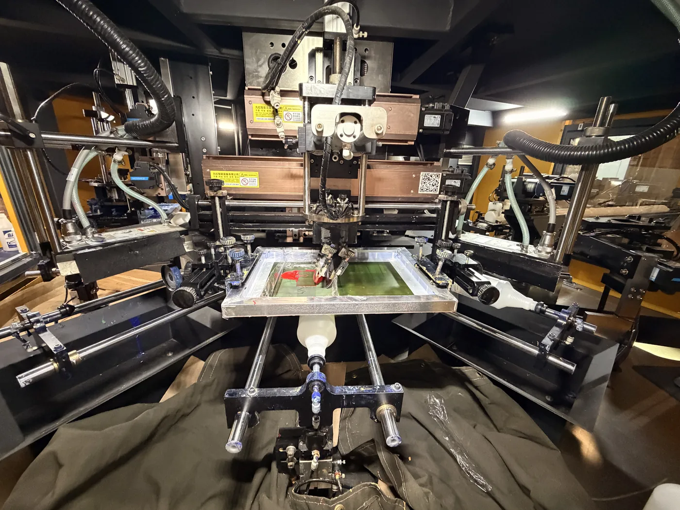 Screen printing press printing a bottle at Inmark