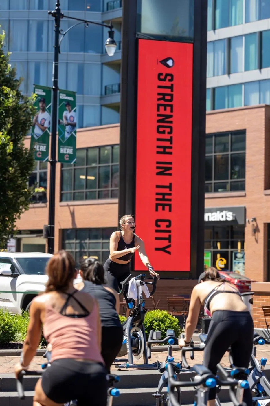 STRENGTH IN THE CITY banner over an outdoor class