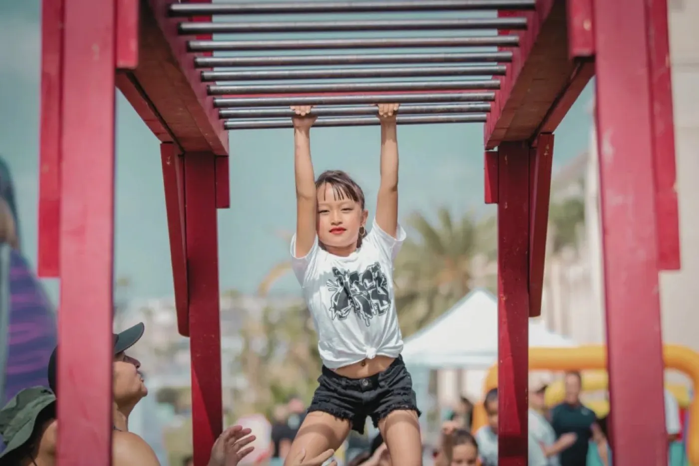 A child on the monkey bars at a festival