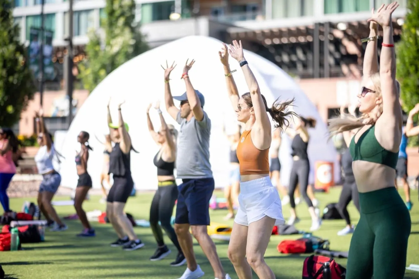 An outdoor STRENGTH IN THE CITY festival class