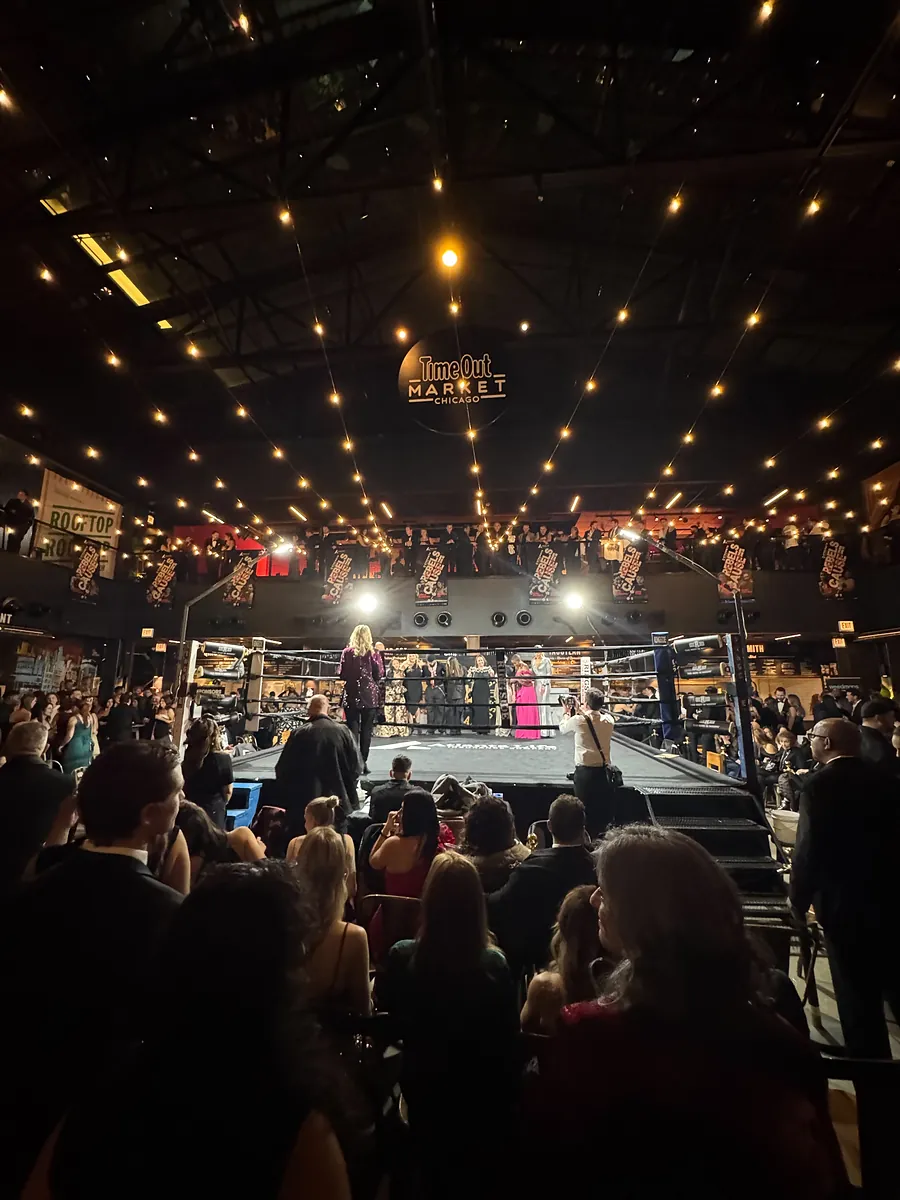 The view from the floor seats toward the ring, under the string lights