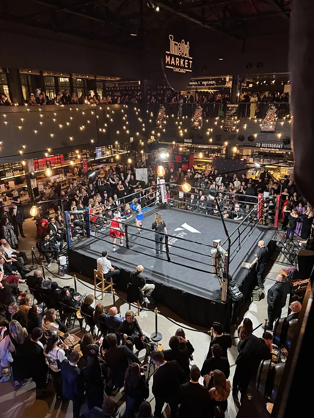 A women's bout, red corner against blue, seen from the balcony