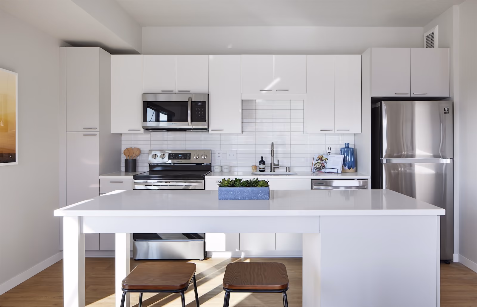 Stainless steel appliances, quartz countertops, and tile backsplashes