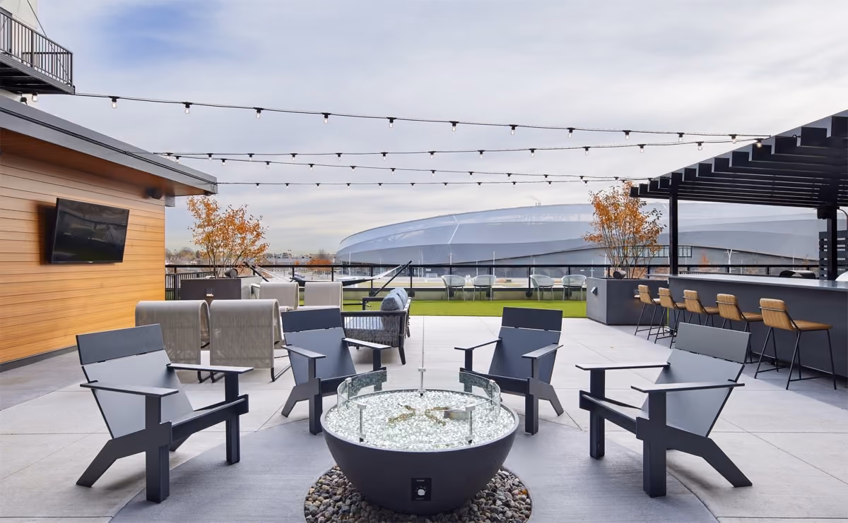 Elevated amenity deck with firepit, sauna, grill stations and dry bar area