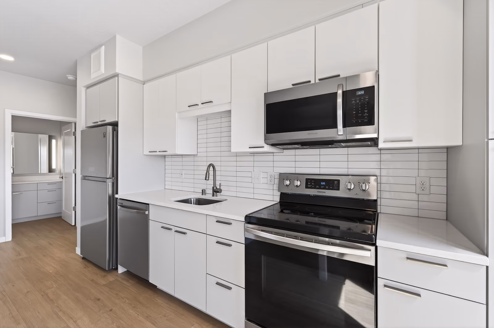 Kitchen with stainless steel appliances at The Pitch Apartments