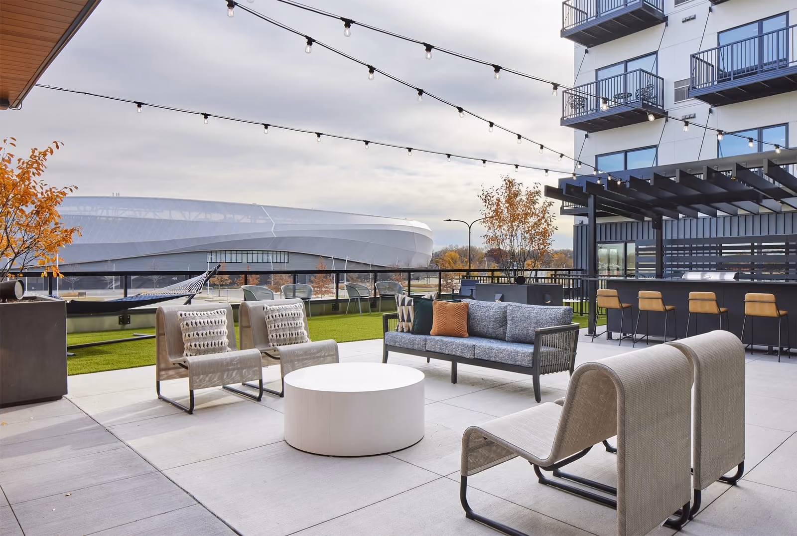 Elevated amenity deck with firepit, sauna, grill stations and dry bar area