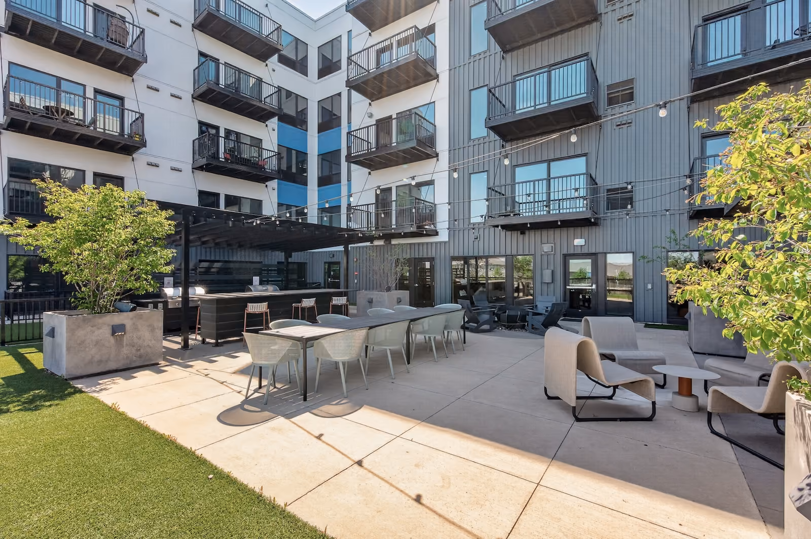 Elevated amenity deck with firepit, sauna, grill stations and dry bar area
