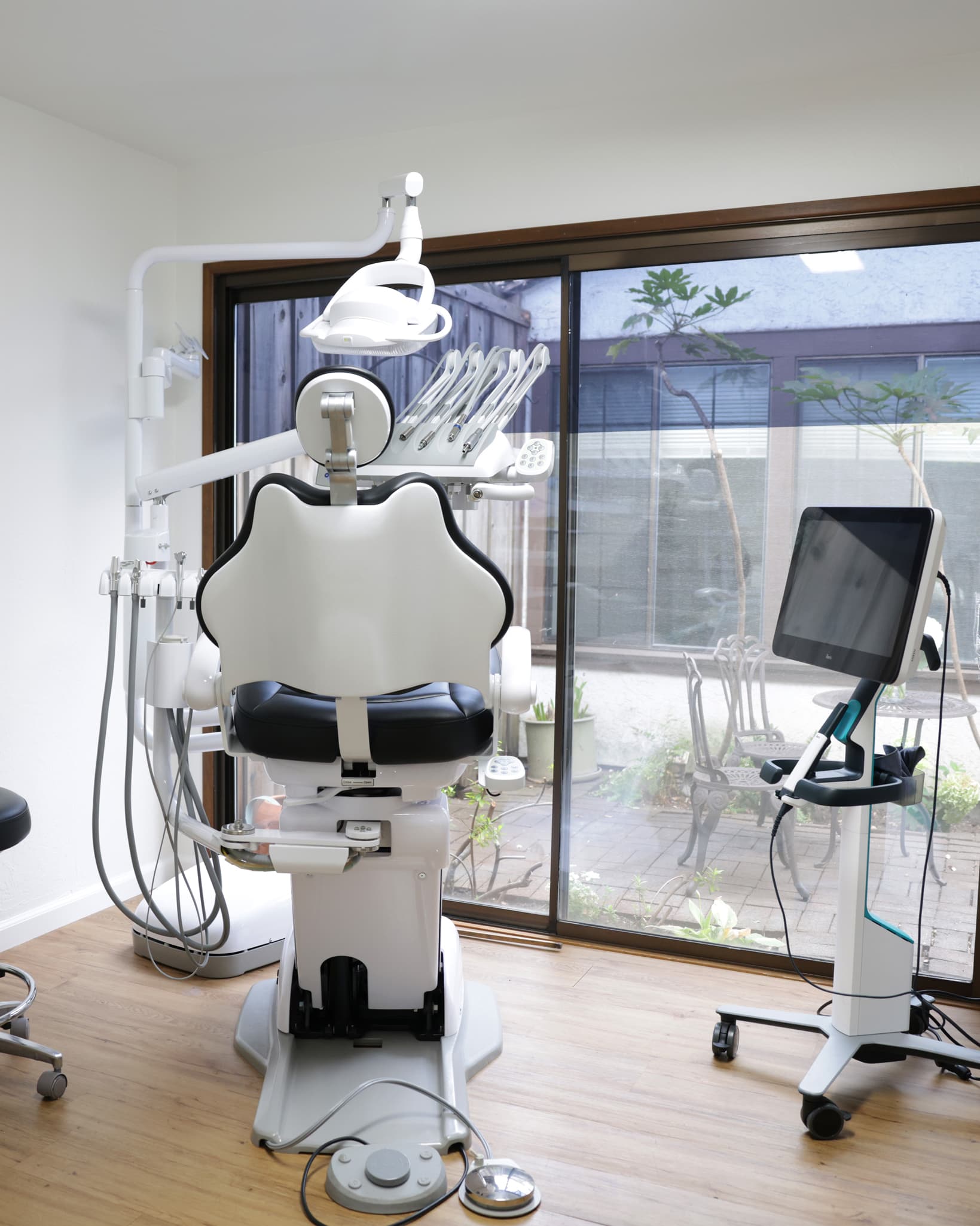 Modern dental chair and digital screen in a sunlit treatment room at our Sonoma, CA dental office