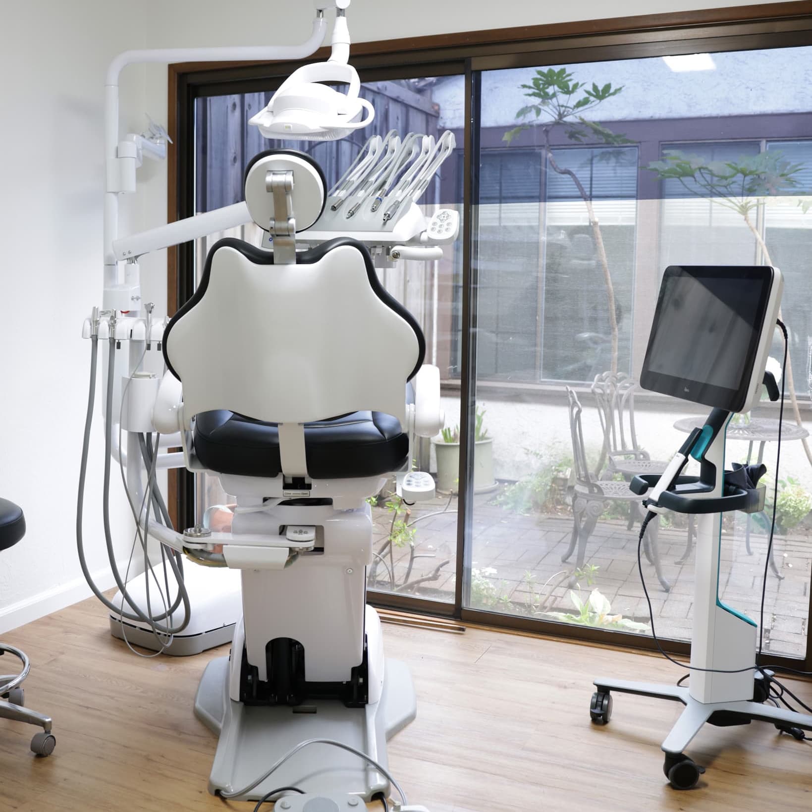 Treatment room with a modern dental chair and garden view at Sonoma Springs Dental in Sonoma, CA