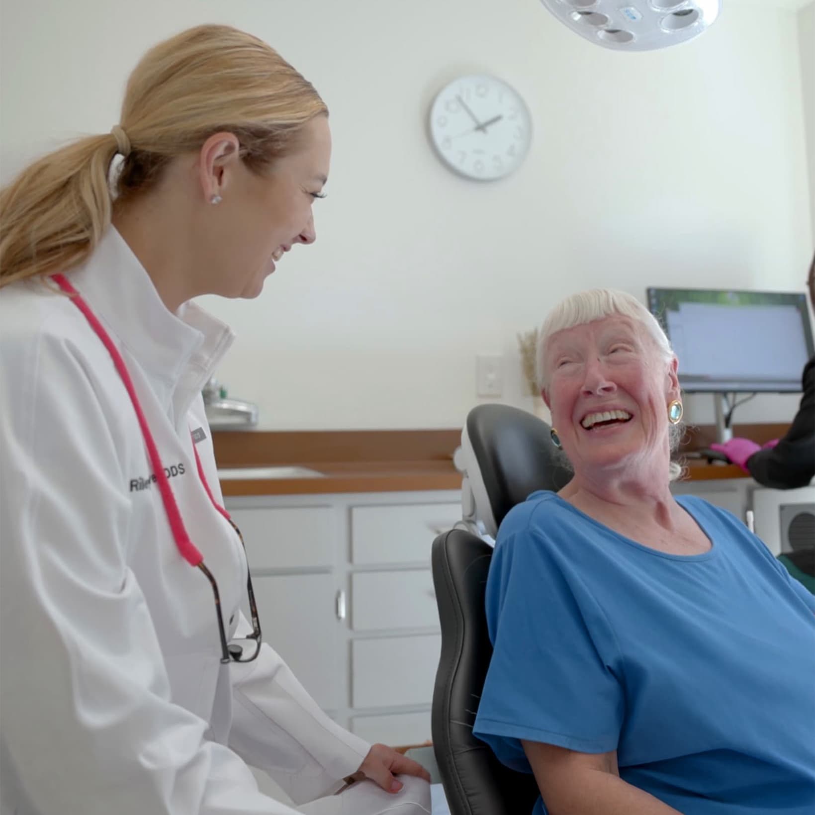 Dr. Riley Oliver laughing with a patient during a dental checkup at her Sonoma, CA dental office