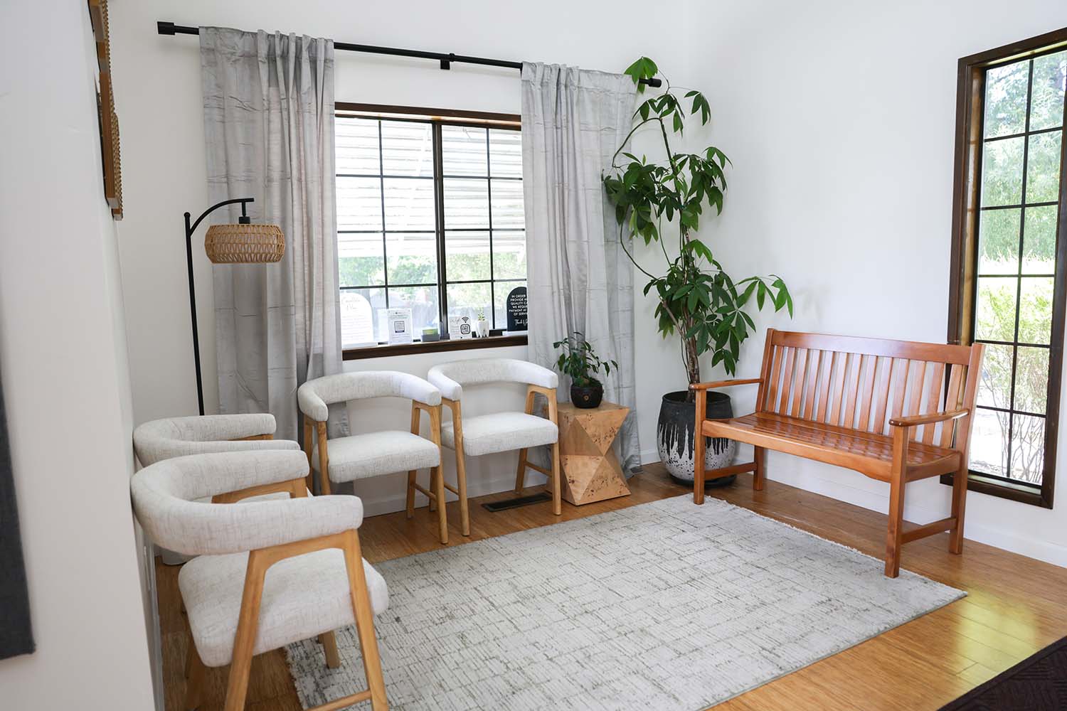 Waiting room at Sonoma Springs Dental, a boutique dentist in Sonoma, CA, with cushioned chairs and a wooden bench