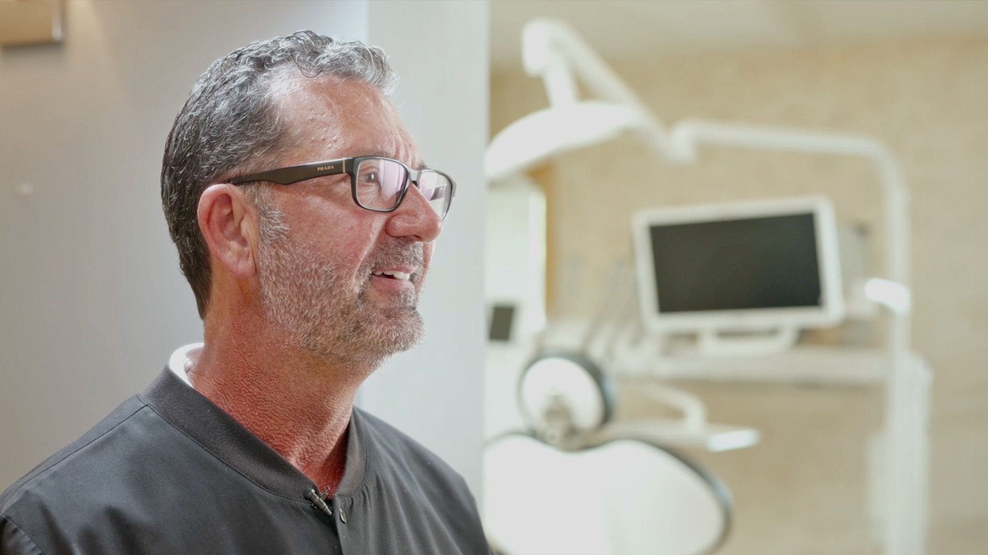 Dr. Kenneth J. Bevan smiling in a modern treatment room at Bevan Dental, dentist in Napa, CA