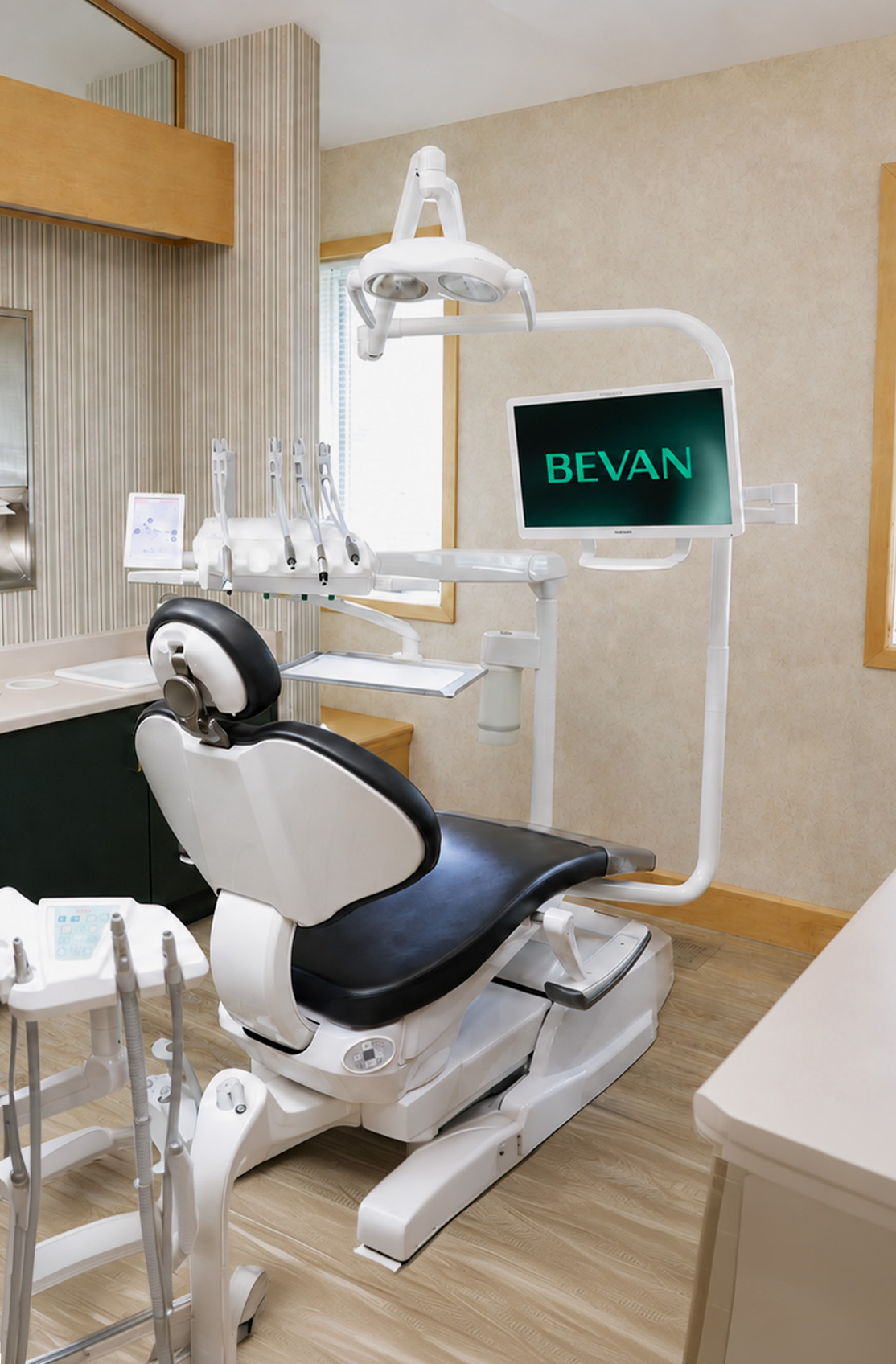 Modern treatment room with a dental chair and digital screen at Bevan Dental, dental office in Napa, CA