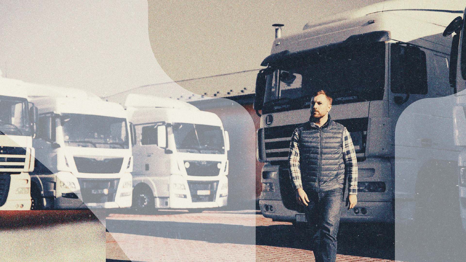 Man walking beside a row of fleet trucks