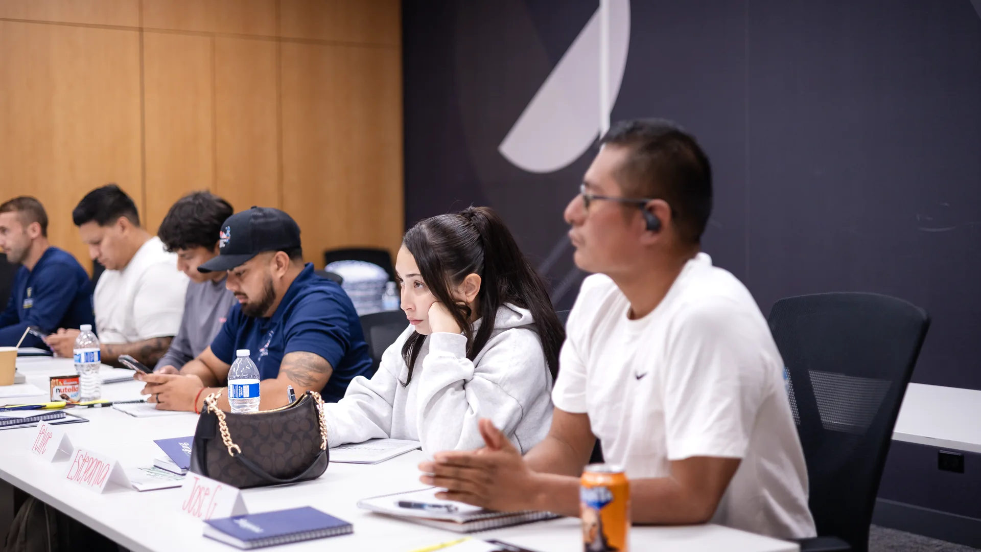 Students taking notes during a live public adjuster exam prep class