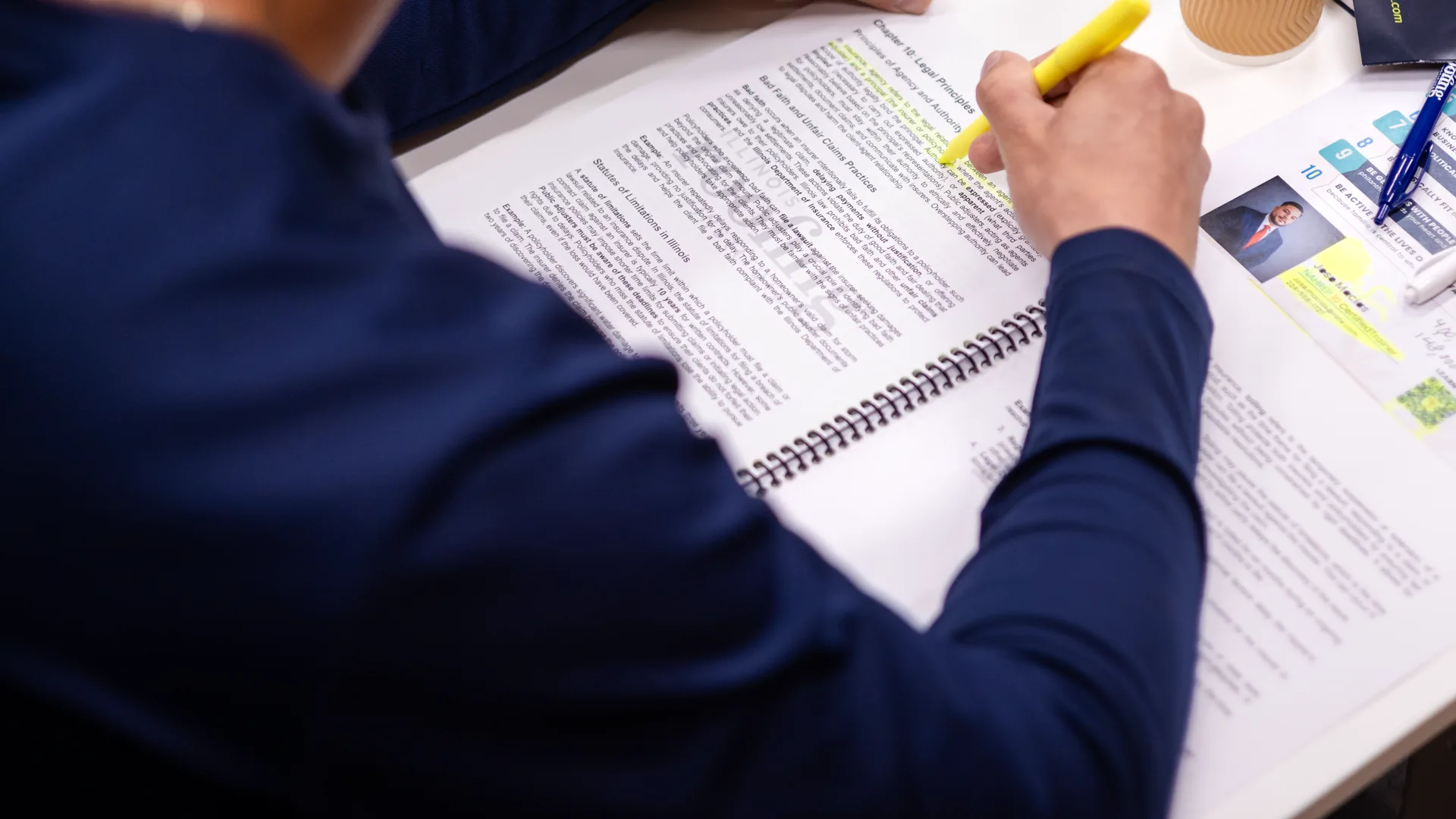Student highlighting the legal principles chapter of the public adjuster course workbook